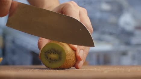 Cut-with-a-knife-on-a-wooden-board-closeup-kiwi-in-the-kitchen.-shred
